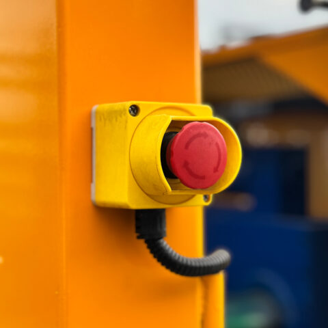 Closeup of emergency stop button on tyre debeader