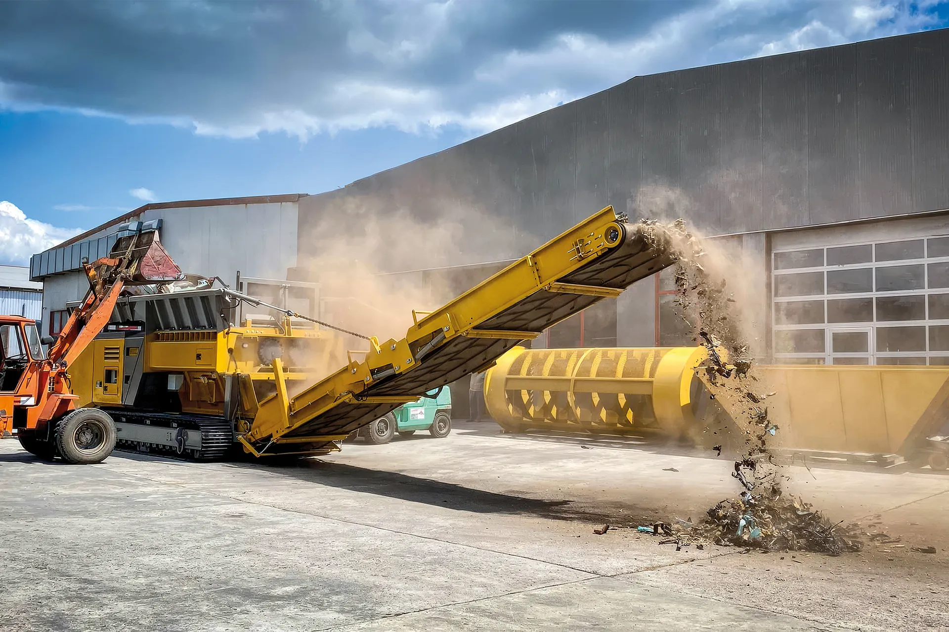 Olnova mobile shredder being loaded by loader and processing scrap metal