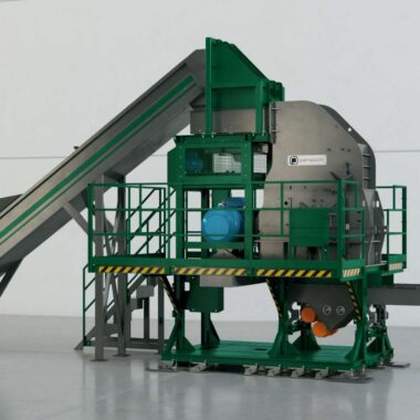 Industrial waste processing hammer mill with conveyor system in a factory setting.