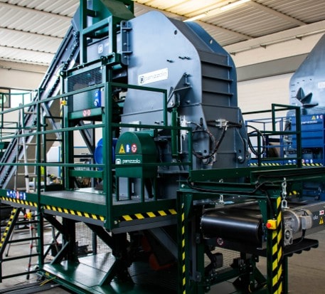 Industrial hammer mill for waste processing and recycling.