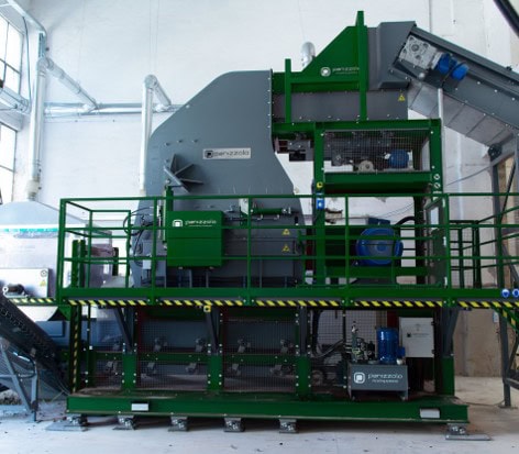 Industrial waste processing hammer mill for recycling and waste management.