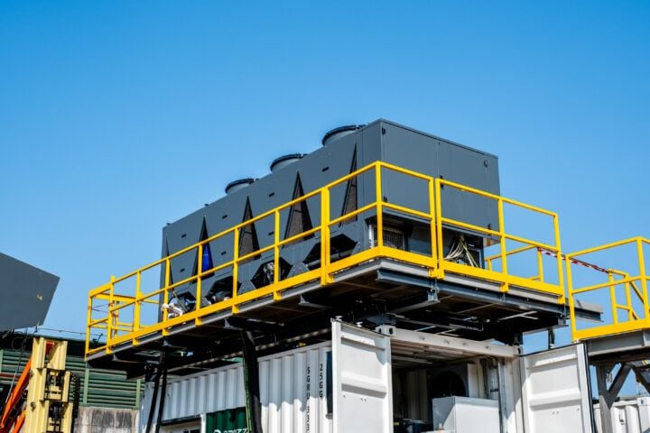 Industrial pre-shredder machinery on elevated platform with safety railings.