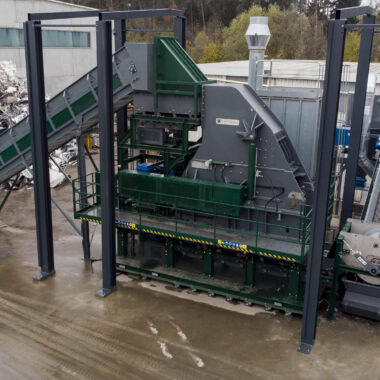 Industrial waste processing hammer mill for recycling and waste management.