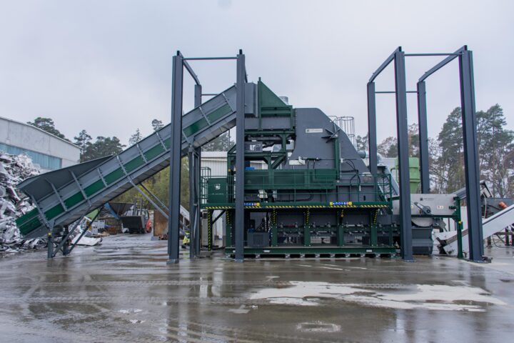 Industrial waste processing hammer mill for recycling and waste management.