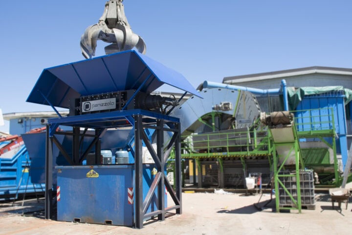 Heavy-duty industrial shredder for waste recycling and material reduction.