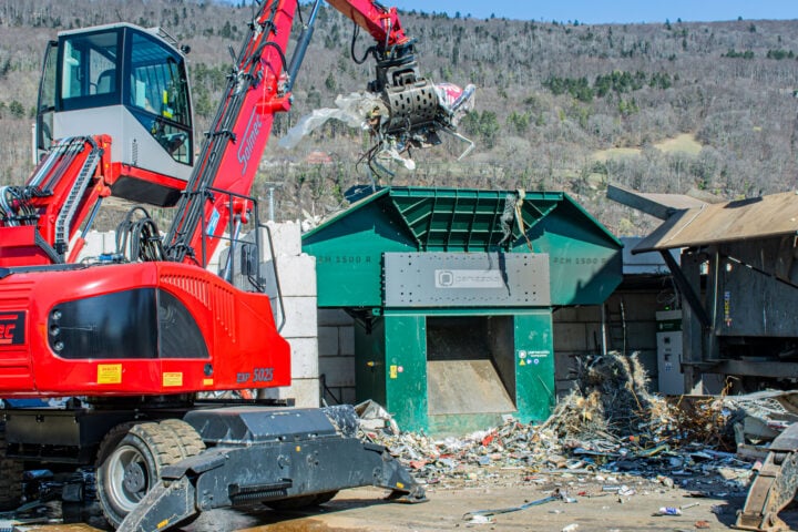 Heavy machinery recycling waste at a landfill site in Australia.