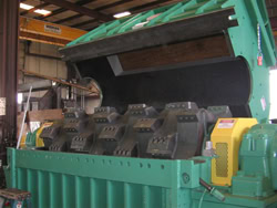 Industrial tyre grinder for waste recycling and tyre processing.