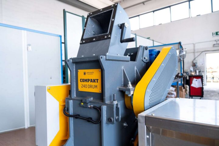 Industrial waste shredder for recycling and waste processing.